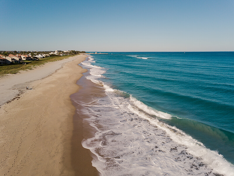 Waves cresting a sandy beach.