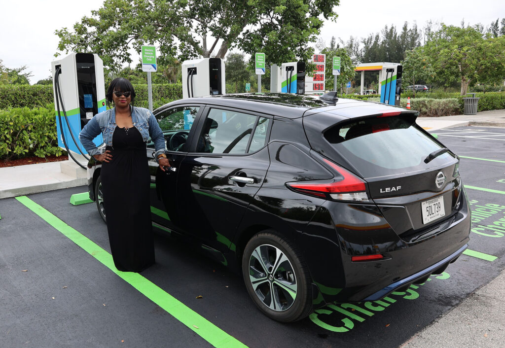 Woman at an electric vehicle charging station