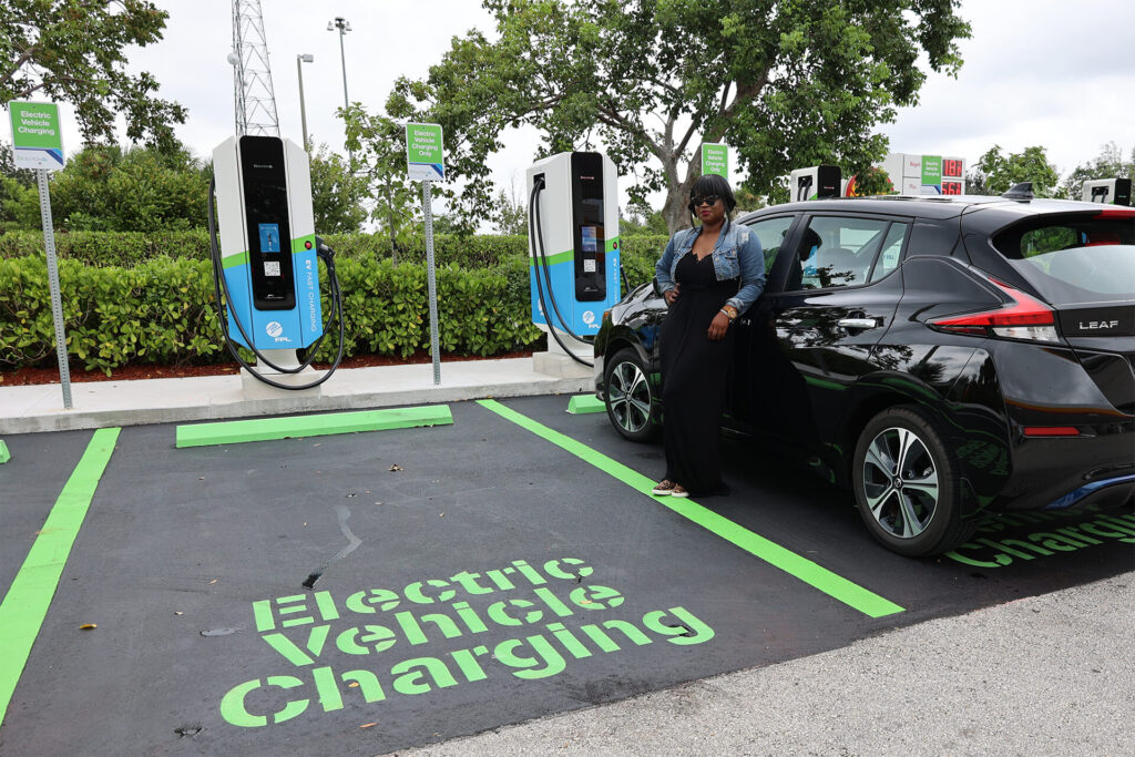 Woman at Electric Vehicle charging station
