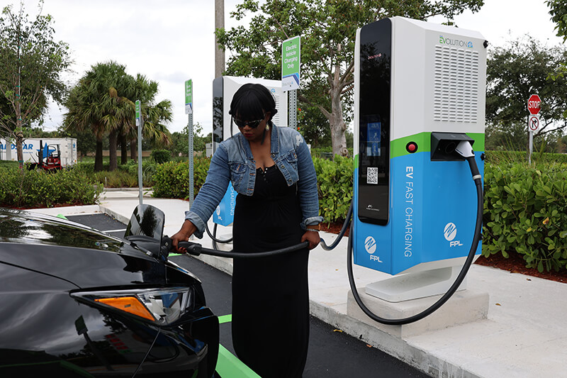 Woman at an electric vehicle charging station