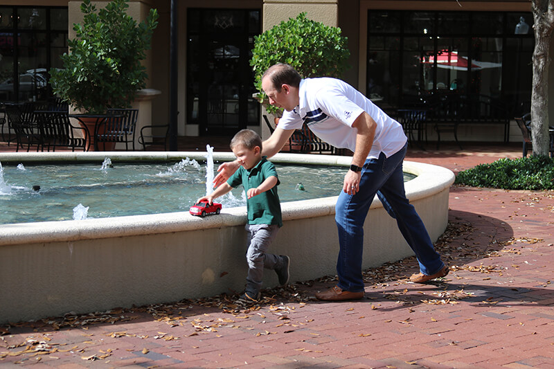 Cam and Nathan playing on a fountain
